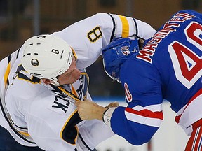 Two former Belleville Bulls, Cody McCormick of the Buffalo Sabres and Brandon Mashinter of the New York Rangers, fight during an NHL game earlier this season. (QMI Agency)