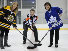 W. BRICE MCVICAR The Intelligencer
Sue Rollins, Belleville General Hospital Foundation event organizer (left) and Ana Bento, community manager for Scotiabank, wait for Bill Newman to drop the puck as part of the Scotiabank Legends of Hockey event. The foundation fundraiser, scheduled for January, will see Toronto Maple Leafs and Boston Bruins alumni team square off against one another.