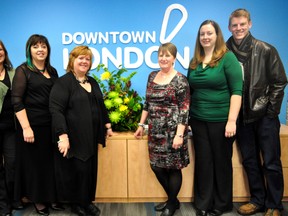 Downtown London staff stand next to a logo in the front of their new offices at 123 King Street in London Ont. Nov. 13, 2013. Pictured from left to right: Vicki Smith, financial advice co-ordinator, Lisa Thomas, marketing co-ordinator, Kathy McLaughlin, program co-ordinator, Janette MacDonald, executive director, Sarah Franklin, research technologist, Andrew Sercombe, super guide. CHRIS MONTANINI\LONDONER\QMI AGENCY