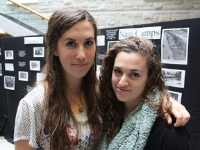 Queen's University students Zoey Katz, left, and Elana Moscoe are among the organizers of a Holocaust display set up on campus this week to mark Holocaust Education Week.
Michael Lea The Whig-Standard