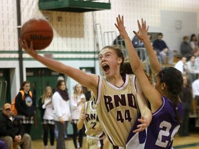 Regiopolis-Notre Dame Panthers' Bridget Mulholland goes for a layup over Thousand Islands Secondary School Pirates' Denae VanBlitterswyk in the Eastern Ontario Secondary Schools Athletic Association senior girls basketball championship played at Holy Cross Secondary School on Wednesday.  Ian MacAlpine/The Whig-Standard