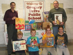 The Lambton-Kent District School Board donated more than 500 French-language books to the Mission To Haiti charity. Front row, from left: Students Nate, Benjamin and Rebecca Lewis and Jaedyn Stoddart. Back row: Gregory Drive Public School principal Lance Balkwill and Robert Lewis.