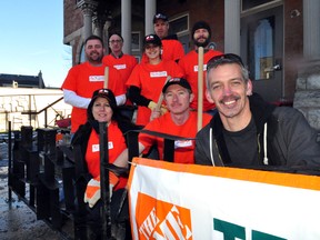 Londoners who gave a helping hand with a restoration job at the Unity Project stand next to the east end shelter’s new metal fence in London Ont. Nov 14, 2013. Pictured is local artist Richard Sturgeon, Home Depot volunteers Joe Jackson, Montse Lamas, Mariah Gallant, Mike Lafferty, Jeff Lee, Unity Project staff member Greg Wiebe and Unity Project resident James Middlemiss. CHRIS MONTANINI\LONDONER\QMI AGENCY