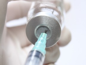 a needle is charged with vaccine