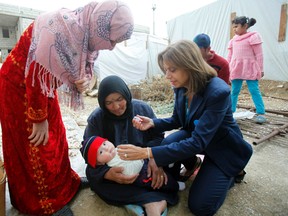 Annamaria Laurini, UNICEF representative in Lebanon, administers a polio vaccine to a baby at a Syrian refugee camp near Zahle town in the Bekaa Valley. Lebanon launched a massive public health initiative on Friday to vaccinate all children under five against polio, following a confirmed outbreak of the crippling disease last month in neighbouring war-torn Syria. 
QMI AGENCY/REUTERS/Sharif Karim