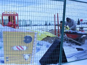 Darin Soetaert (left) and James Strauss of South Brook Contracting, Strauss Development, install St. Marguerite’s new playground equipment on Nov. 12. - Karen Haynes, Reporter/Examiner