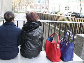 Two women, who cannot be identified, talk about the crimes of Raymond Coles who was sentenced Nov. 15, 2013 to four years in prison. (Veronica Henri/Toronto Sun)