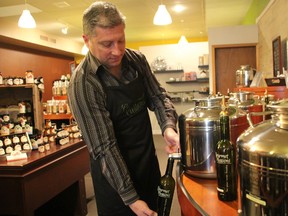 Bruce Middleton demonstrates the olive oil bar at his new gourmet food store in Sarnia, Gourmet Passions. The store specializes in olive oils, chocolates, loose leaf teas, spices, and sauces. (TYLER KULA, The Observer)