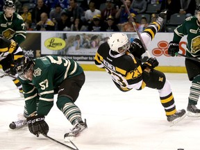 The Kingston Frontenacs' Henri Ikonen gets upended by London Knights' Brady Austin during Ontario Hockey League action at the Rogers K-Rock Centre on Friday.
IAN MACALPINE/KINGSTON WHIG-STANDARD/QMI AGENCY