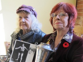 Helen O'Connor, 79, left, and Stella Wojas, 67, the remaining two daughters of Harold 'Hoot' Gibson hold some of the trophies he won over the years. (Paul Schliesmann/Whig-Standard)