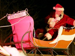 Santa Claus waves to crowds lining the sidewalks of downtown Belleville, ON., Sunday evening for the annual Santa Claus parade, Nov. 17, 2013. 
EMILY MOUNTNEY/THE INTELLIGENCER/QMI AGENCY