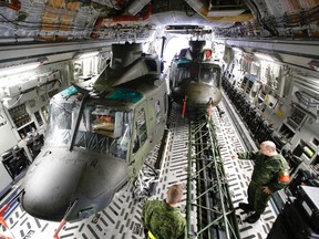Crews from 2 Air Movements Squadron (Trenton) and 400 Squadron (Borden) load a second CH-146 Griffon helicopter into a C-17 Globemaster aircraft at 8 Wing/CFB Trenton, Ont. Sunday, Nov. 17, 2013, part of Canada's ongoing relief mission in the Philippines.  - JEROME LESSARD/The Intelligencer