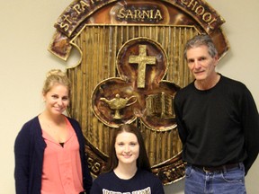 Caroline Hummel (middle) is pictured with her basketball coaches Lindsay Sharpe and Ed Dragan as she signs her National Letter of Intent to play basketball for Mount St. Mary's University. Hummel will be going to the NCAA Division 1 school on a scholarship beginning in 2014. SHAUN BISSON/ THE OBSERVER/ QMI AGENCY