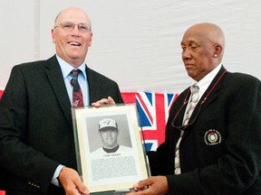 Former Toronto Blue Jay Tom Henke, left, is presented with a plaque from 1997 inductee Ferguson "Fergie" Jenkins at the 2011 Canadian Baseball Hall of Fame Induction Weekend in St. Marys.  (QMI Agency file photo)