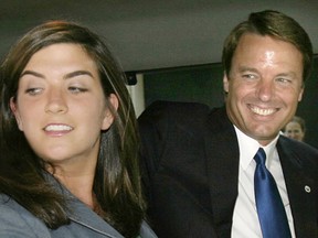 Former U.S. Sen. John Edwards  waits in a van with daughter Cate (L) after departing his Georgetown home with his family in Washington, July 6, 2004.