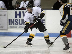 Tillsonburg’s Brad Jones looks to headman the puck as he cruises through the neutral zone, watched by Tavistock’s Chad Swartzentruber. Jeff Tribe/Tillsonburg News