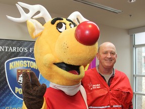 Steve Beattie, a volunteer with Operation Red Nose, poses with the mascot Rudy during Tuesday's official kick-off of the annual service that provides a safe ride home to motorists who have been drinking. (Michael Lea The Whig-Standard)