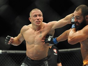 Georges St. Pierre (left) fights Johny Hendricks in their UFC 167 welterweight championship bout at MGM Grand Garden Arena Saturday. (Stephen R. Sylvanie/USA TODAY Sports)