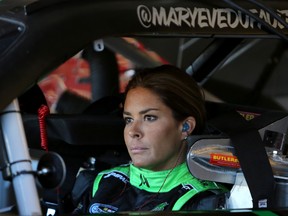 Maryeve Dufault sits in her car during practice for the NASCAR Nationwide Series Dollar General 300 Powered by Coca-Cola at Chicagoland Speedway on September 13, 2013. (Brian Cleary/Getty Images/AFP)
