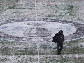 Ticats' Luca Congi walks off the snowy field in Regina on Wednesday. (Reuters)
