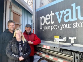 (Left to right) Pet Valu driver Peter Hegger along with wife, and Pet Valu district manager, Leona Hegger present food bank coordinator Herb McGowan with a special delivery Nov. 14.
