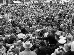 Former U.S. president John F. Kennedy reaches out to the crowd gathered at the Hotel Texas parking lot rally in Fort Worth,Texas, in this handout image taken on November 22, 1963. He was assassinated later in the day in Dallas.
 REUTERS/Cecil Stoughton/The White House/John F. Kennedy Presidential Library