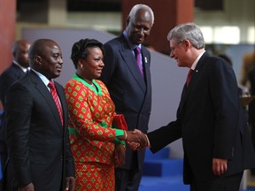 Canada's Prime Minister Stephen Harper greets first lady Olive Kabila and Democratic Republic of Congo President Joseph Kabila (L), as he arrives for the 14th annual Francophonie summit in Kinshasa October 13, 2012.  Former Senegalese president and Francophone Organisation General Secretary Abdou Diouf looks on on the right.
 REUTERS/Noor Khamis