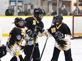 Rylie Dietz (left) and Megan Smith celebrate Carley Dietz's winning goal in the final minute of their U14 ringette game Thursday, Nov. 21 as Mitchell's two teams in this division played one another to kick off the 30th annual Mitchell Stingers ringette tournament at the Mitchell & District Arena. The U14 Rose team edged the U14 Rock team, 6-5. ANDY BADER/MITCHELL ADVOCATE