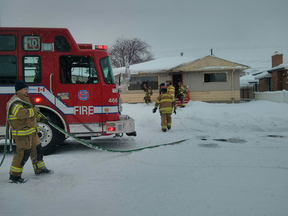 Firefighters pulled an unresponsive man from this northside house, near 80 Street and 129A Avenue, after a home care worker arrived to find smoke inside. (Perry Mah/Edmonton Sun)