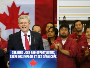 Prime Minister Stephen Harper speaks at Fort Garry Fire Trucks after formally opening CentrePort Canada Way in Winnipeg, November 22, 2013. REUTERS/Trevor Hagan