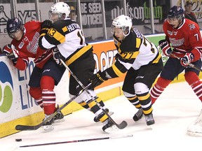 Kingston's Ryan Hutchinson takes Oshawa's Matt Hore out of the play while Frontenacs defenceman Warren Steele goes for the puck during Friday night's OHL game at the Rogers K-Rock Centre. (Michael Lea/The Whig-Standard)