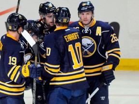Buffalo Sabres center Cody Hodgson (19), defenseman Christian Ehrhoff (10) and left wing Thomas Vanek (26) celebrate Vanek's goal with teammates, against the Winnipeg Jets during the second period of their NHL hockey game in Buffalo, New York April 22, 2013. (REUTERS/Doug Benz)