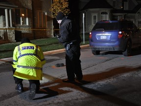 Halton Regional Police investigate the death of an 83-year-old man after being struck by a minivan on a Midland residential street on Nov. 22, 2013. (David Ritchie/Special to the Toronto Sun)