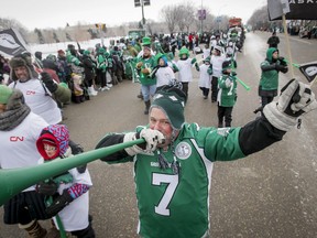 Riders superfan Scott Croissant blasts his horn while marching in the Grey Cup Parade in Regina yesterday during temperatures that dropped to a frigid -37C. (Lyle Aspinall/QMI AGENCY)