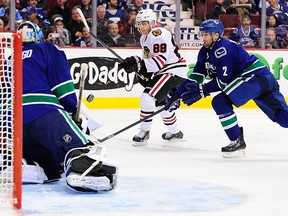 Chicago Blackhawks forward Patrick Kane (88) has a scoring chance against Vancouver Canucks goaltender Roberto Luongo (1) and defenseman Dan Hamhuis (2) during the second period at Rogers Arena. (Anne-Marie Sorvin-USA TODAY Sports)