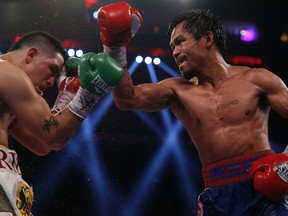 Manny Pacquiao of the Philippines fights Brandon Rios (L) of the U.S. during their World Boxing Organization (WBO) International 12-round welterweight boxing title fight at the Venetian Macao hotel in Macau November 24, 2013. REUTERS/Tyrone Siu