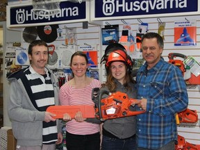 Colin Linklater, Ashley Lewis and Holly Castellani, the Whiskerino sub-committee for Carnival, and Gerry Bourque from Bourque's Auto with  the Whiskerino first place prize, a Husqvarna 545 chainsaw.