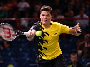 Milos Raonic hits a return to Robin Haase at the Paris Masters tennis tournament at the Palais Omnisports of Bercy October 30, 2013. (REUTERS/Charles Platiau)