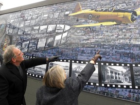 Wendy Ouellette and Dave Shoniker of the Trent Port Historical Society look at the community mosaic mural unveiled Saturday in downtown Trenton. More than 3,500 images were used by Prescott artist Charles Street. Ernst Kuglin photo