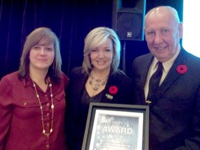 Drayton Valley  Comprehensive Family Violence Institute board chair Gord Chammen (right) and board member Lola Strand (far left) accept the Alberta Inspiration Award from Associate Minister of Family and Community Safety Sandra Jansen  (centre) in recognition of the work it’s done to combat family violence in the community.