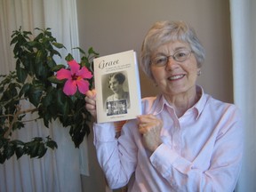 Author Millie Morton holds up her book "Grace: A Teacher’s Life, One-room Schools and a Century of Change in Ontario."