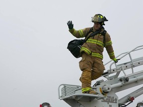 A firefighter is lifted onto the roof of the Lambton Mall during the 2012 campout.
SUBMITTED PHOTO