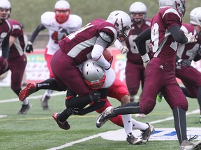 A Frontenac Falcons player is tackled by a Lorne Park Spartans defender during an OFSAA bowl game at Centennial Stadium in Etobicoke Tuesday. Lorne Park won 32-1. (Stan Behal/QMI Agency)