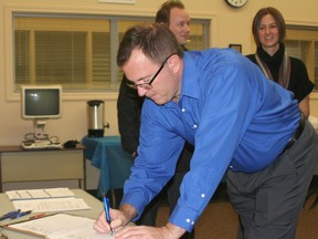 Prosperity Roundtable member Darrin Canniff signs the Cities Reducing Poverty Charter on Nov. 25.