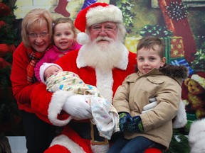 Santa promises to return to St. Thomas on Sunday so he can meet with boys and girls at the Alzheimer Society Elgin-St. Thomas' annual Breakfast With Santa fundraiser. Pictured with Santa is Alzheimer Society events coordinator Chris Smith-Heidt, left, and her grandchildren Hannah, Willow and Quinn Smith.