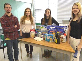 West Elgin Secondary School students left, Jacob White, Kiarah Shaule, Kristen Kirschner and Holly Mateev make preparations for the school's annual food drive.