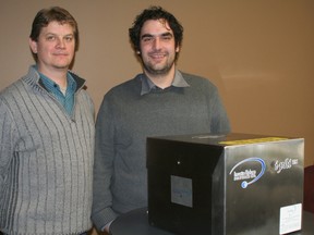 Dan Brown, left and Jonathan Doerksen pose on Wednesday, Nov. 27, 2013 with an i-phi hydrogen generation module like the ones they will be manufacturing in Blenheim.