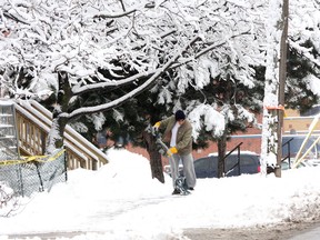 A man shovels along Rideau Street after about 15 centimetres of heavy and sticky snow fell on the Kingston area overnight Tuesday and Wednesday.
IAN MACALPINE/KINGSTON WHIG-STANDARD/QMI AGENCY
