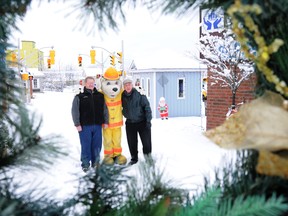 W. BRICE MCVICAR The Intelligencer
Tom Crosbie, chairman of the Children's Safety Village (left) and vice-chairman Richard Hanson stand with Sparky the Fire Dog at the village at the police station. Christmas in The Village, which will include treats, hot chocolate and chili, takes place Friday between 5 p.m. and 8 p.m.