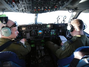 Pilot and co-pilot with 429 Transport Squadron at 8 Wing/CFB Trenton Capt. Kyle Welsh, right, and Capt. Max Harrison are  in command of a C-17 Globemaster flight bound for the Philippines Wednesday, Nov. 27, 2013. The flight loaded with vehicles and equipment left CFB Trenton bound for CFB Edmonton and later reached CFB Comox in British Columbia, before it continues its journey to the Philippines later this week. - JEROME LESSARD/The Intelligencer/QMI Agency